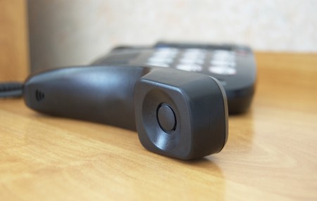 Black phone receiver on the table