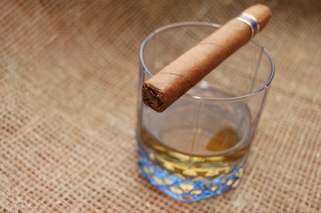 Cuban cigar on glass with wiskey