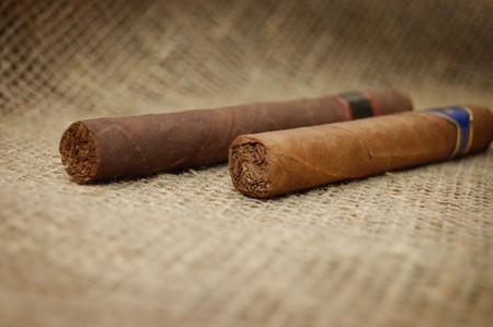 Two cuban cigars on hessian canvas