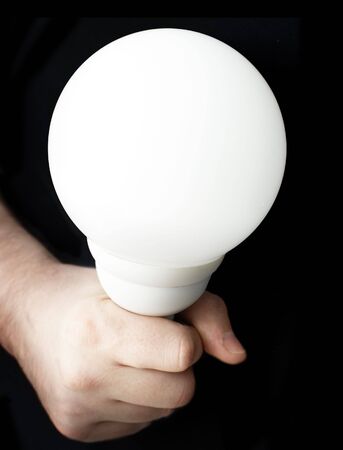 Man hand with lightbulb on black background