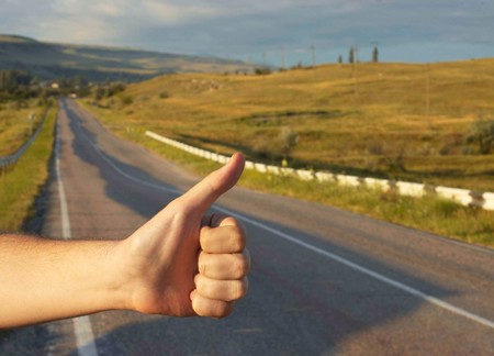 Hand of hiker man at rural mountain road. Daybreak.の写真素材