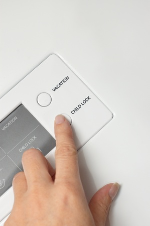 Woman hand press button child lockの写真素材