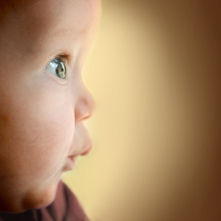 Baby boy with surprised look. Space for text.の写真素材