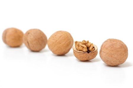 Open walnut in kine with closed nuts. Concept of unique. Focus on core.