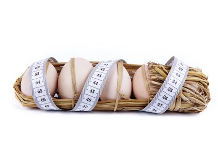 eggs with meter isolated on white backgroundの写真素材