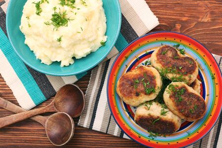 Fried savory tuna patties with potato in the bowl on wooden tableの写真素材