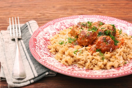 Meatballs in tomato sauce with rice in a bowlの写真素材