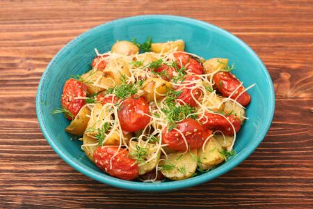 Fried potato and tomato salad with cheeseの写真素材