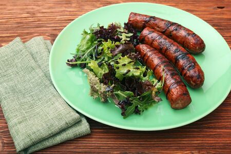 Grilled sausages with greensの写真素材