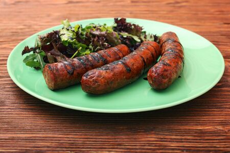 Grilled sausages with greensの写真素材