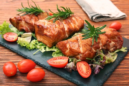 Homemade smoked ham on a boardの写真素材