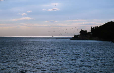 Lonely yacht in the sea on sunsetの写真素材