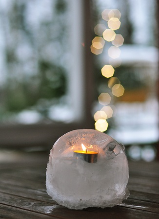 Burning candle on a blurr lights backgroundの写真素材