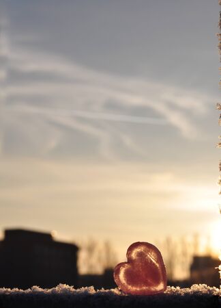 Lonely ice heart with the city skylineの写真素材