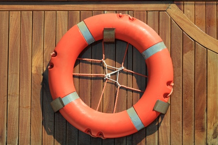 Lifebuoy hanging on wooden wall