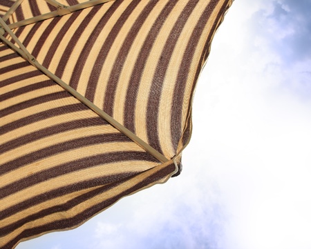 Detail of beach umbrella opposite sun light