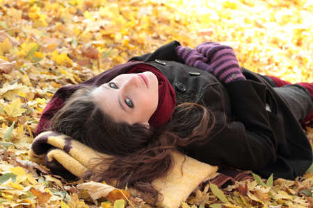 Young woman at the autumn parkの写真素材