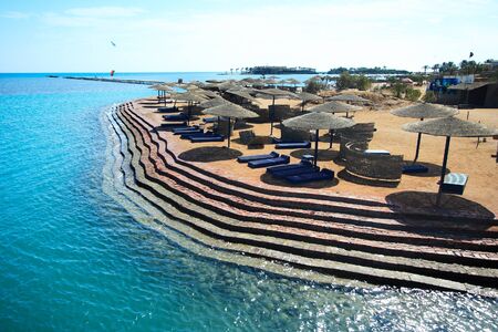 Wicker Beach Umbrella with wicker wind breaks のeditorial素材