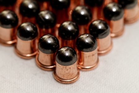 Gun bullets over white background