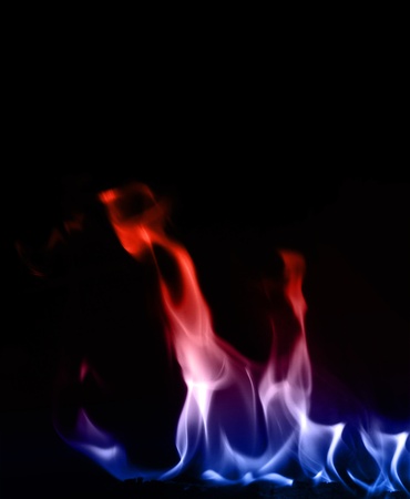 Blue and red flame isolated on dark backgroundの写真素材