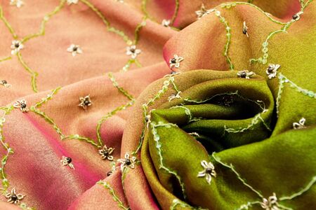 Pink and green satin textile background (close up)の写真素材