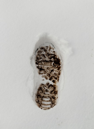 Muddy Footprint in the fresh white snowの写真素材