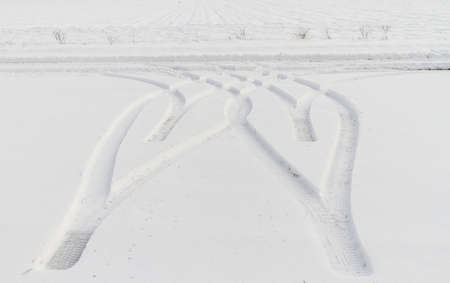 Traces from wheels of the car on snowの写真素材