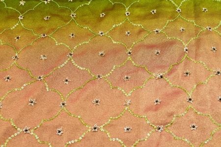 Pink and green satin textile background (close up)