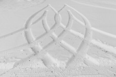 Traces from wheels of the car on snowの写真素材