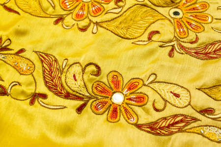 Yellow satin textile background (close up)の写真素材