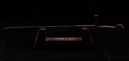 Antiqued knife of envelope aganst a dark background