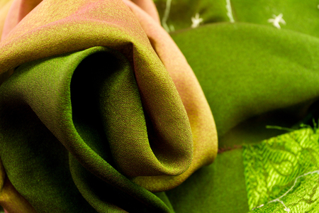 Pink and green satin textile background (close up)の写真素材