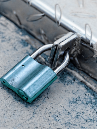 A padlock on an iron door - close-up