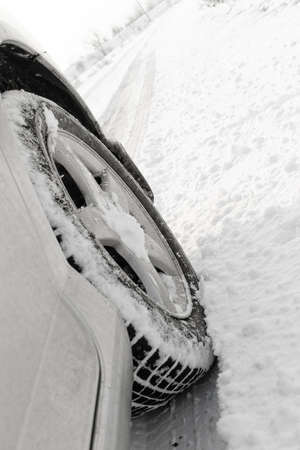 Close up of a cars tires on a snowy road