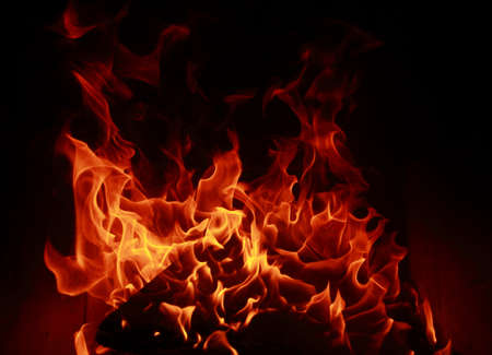 Fire flames with reflection on dark backgroundの写真素材