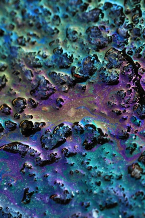 Color gasoline fuel spot on black asphalt, industrial details concept