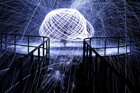 Showers of hot glowing sparks from spinning steel wool