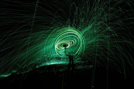 Showers of hot glowing sparks from spinning steel woolの写真素材