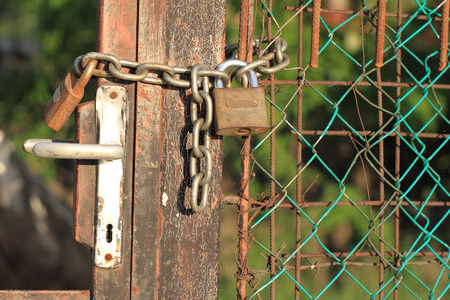 Close up photo of a locked gateの写真素材