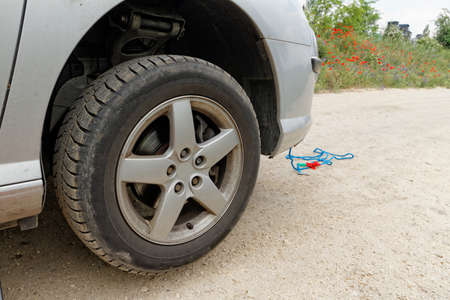 Photo of a car wheel replacement on the roadの写真素材