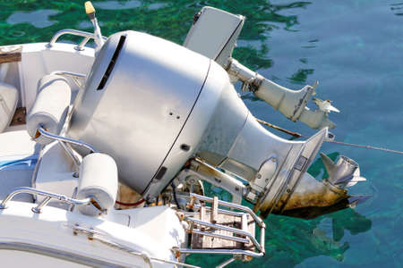 Photo of a grey motorboat engine in the seaの写真素材