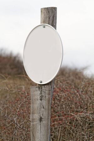 Photo of an old white sign in the meadowの写真素材