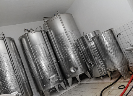 Photo of modern aluminum barrels in the winery