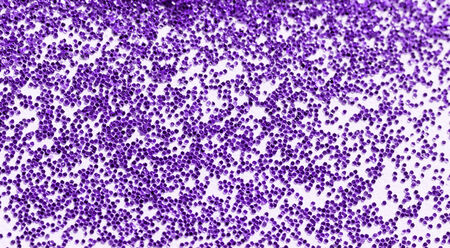 Purple glitter on light background - macro photo