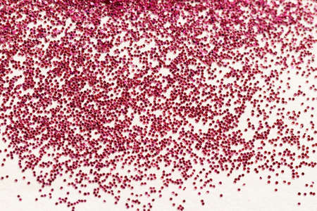 Red glitter on light background - macro photoの写真素材