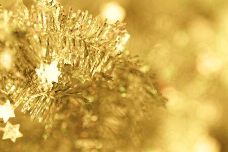 Yellow tinsel Christmas decoration - close-up photoの写真素材