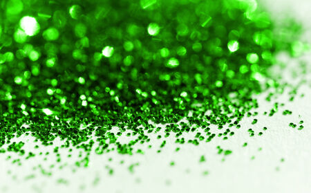 Green glitter on light background - macro photoの写真素材