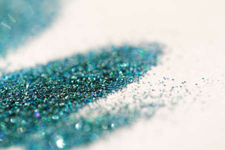 Turquoise glitter on light background - macro photoの写真素材