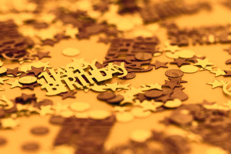 Yellow happy birthday confetti pieces - macro photoの写真素材