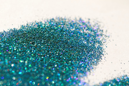 Turquoise glitter on light background - macro photoの写真素材